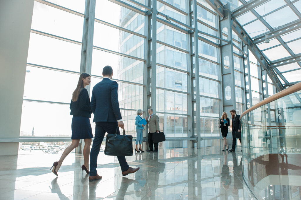 A Group of people walking in a glass hallway